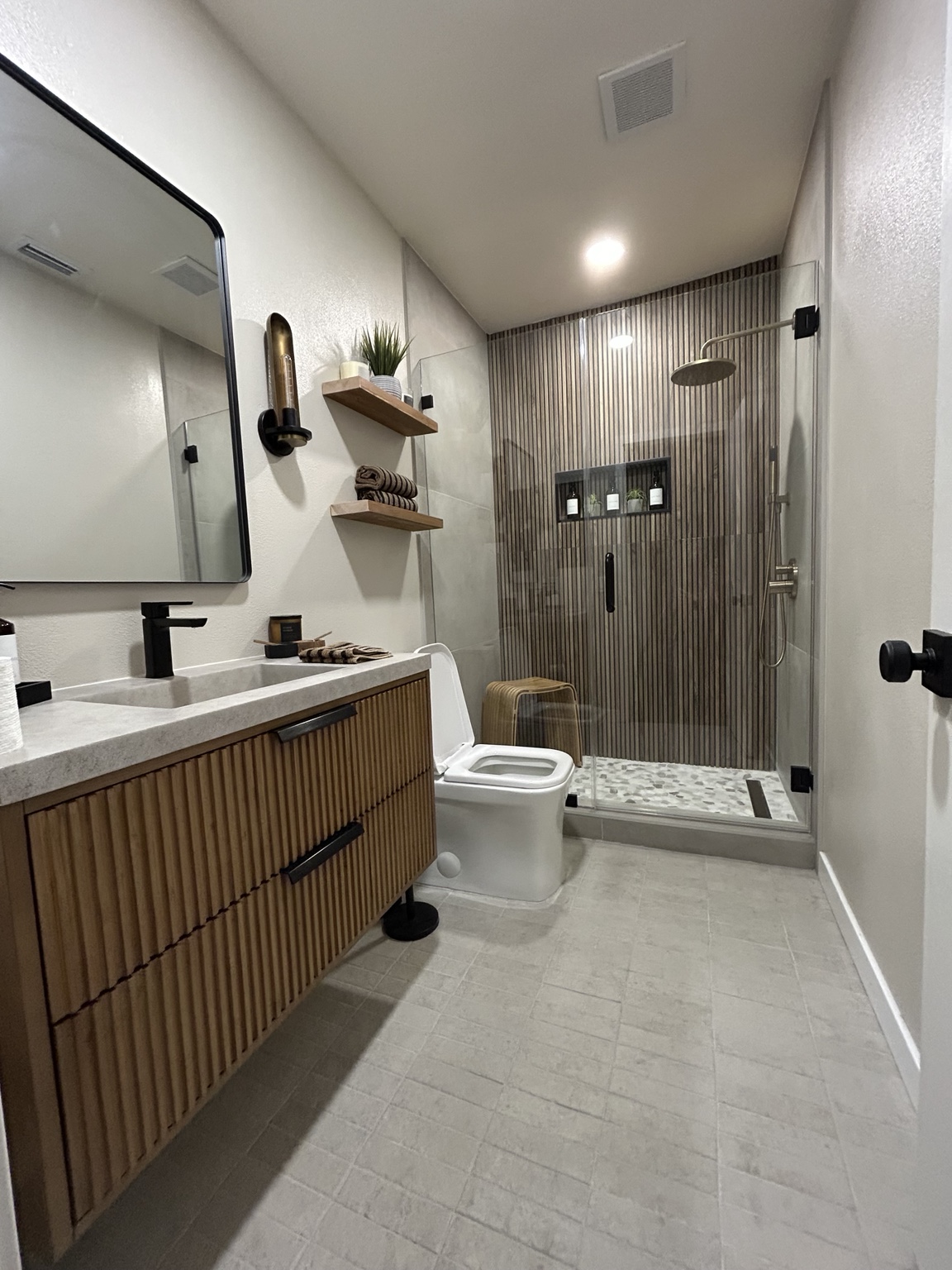 Contemporary bathroom with wood vanity and glass shower